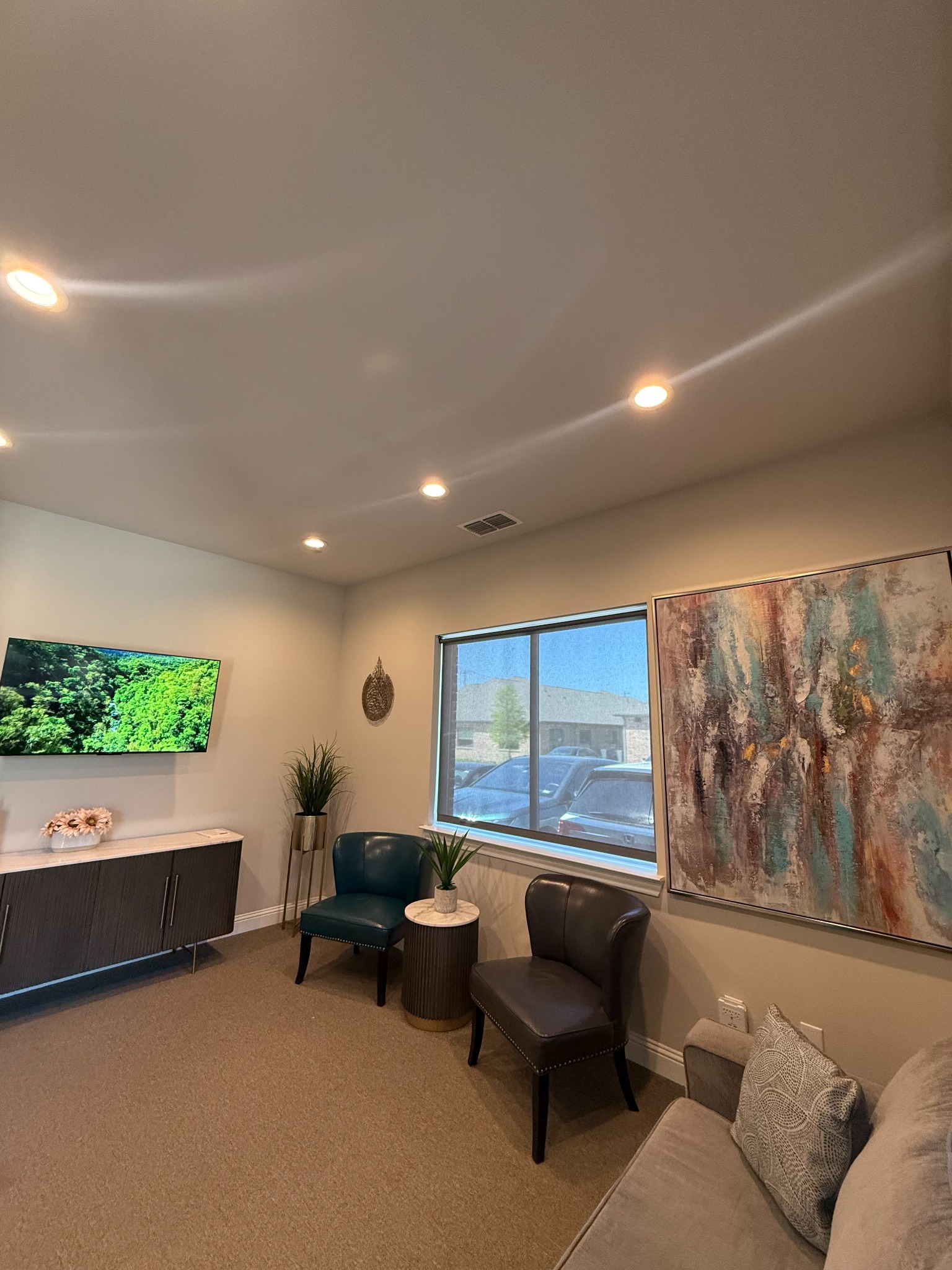 Premier Wellness Clinics waiting area with upholstered chairs, a sofa, plants, and artwork
